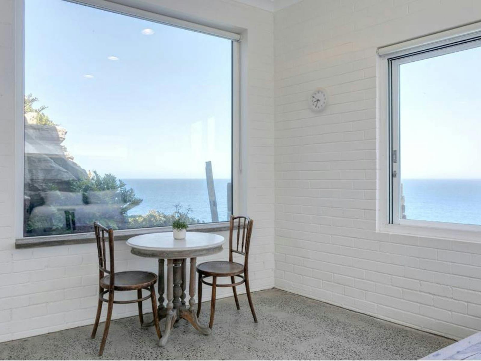 Cliffside apartment with breathtaking views of the ocean and rocky coastline.