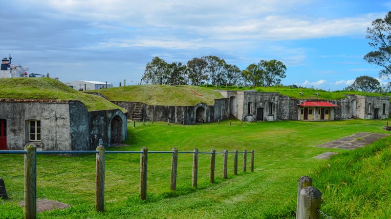 Ruins of Fort Lytton in grassy open space.