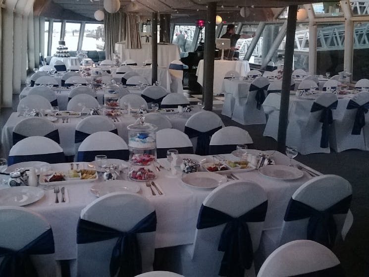 Chairs and tables set up for a wedding onboard 'The Princess".
