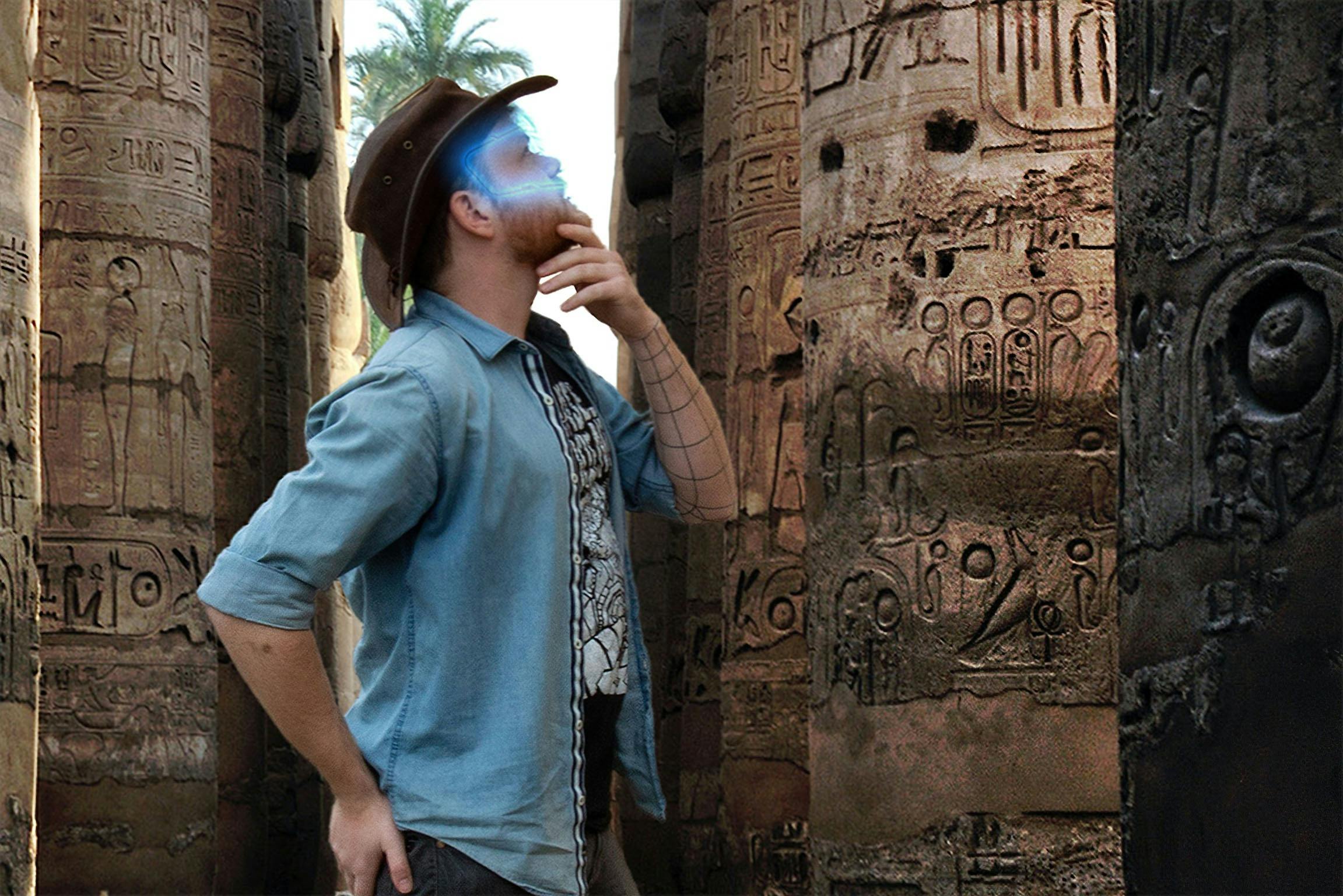 Man with a glowing VR headset exploring ancient ruins in an escape room.