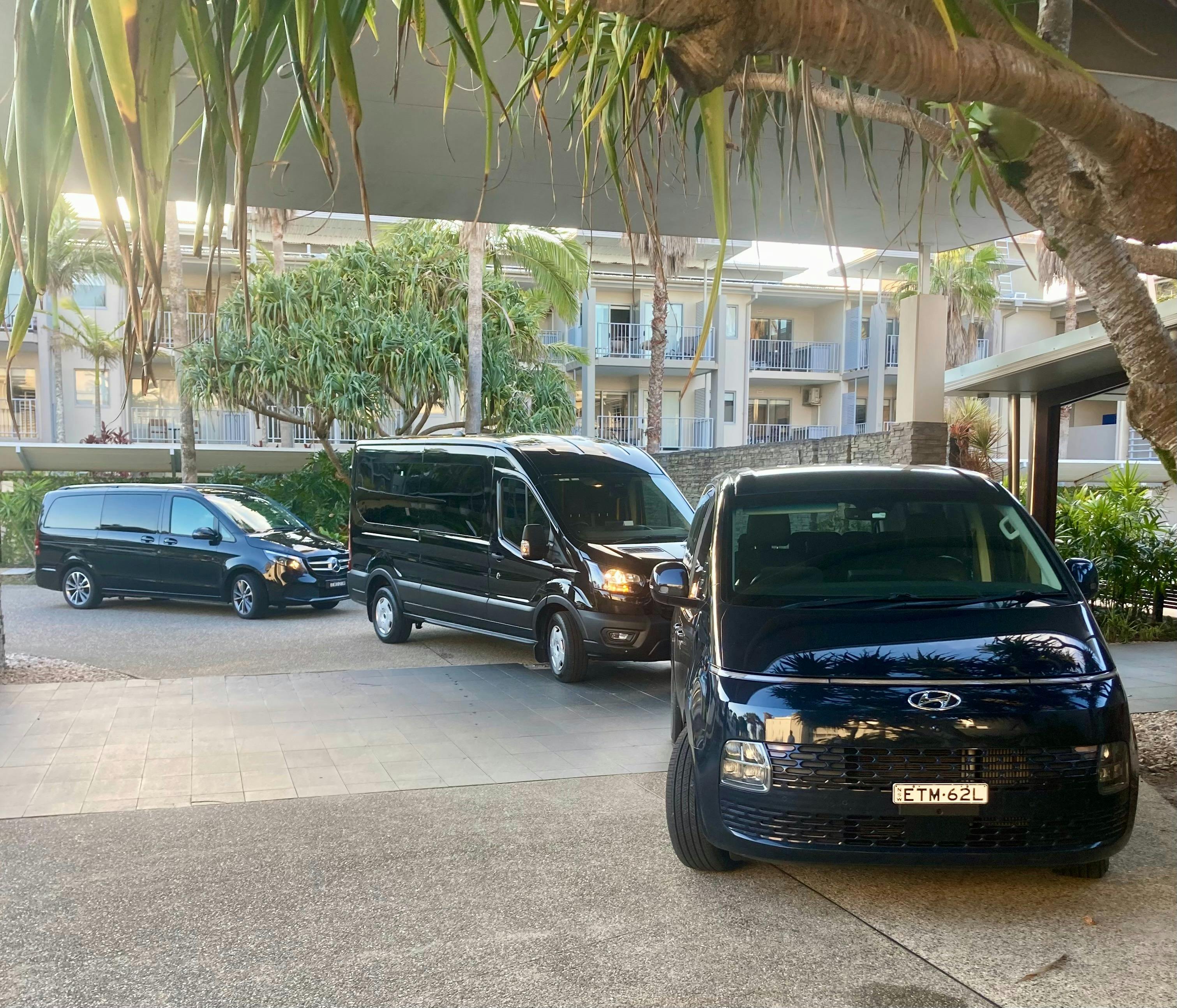 three luxury vehicles