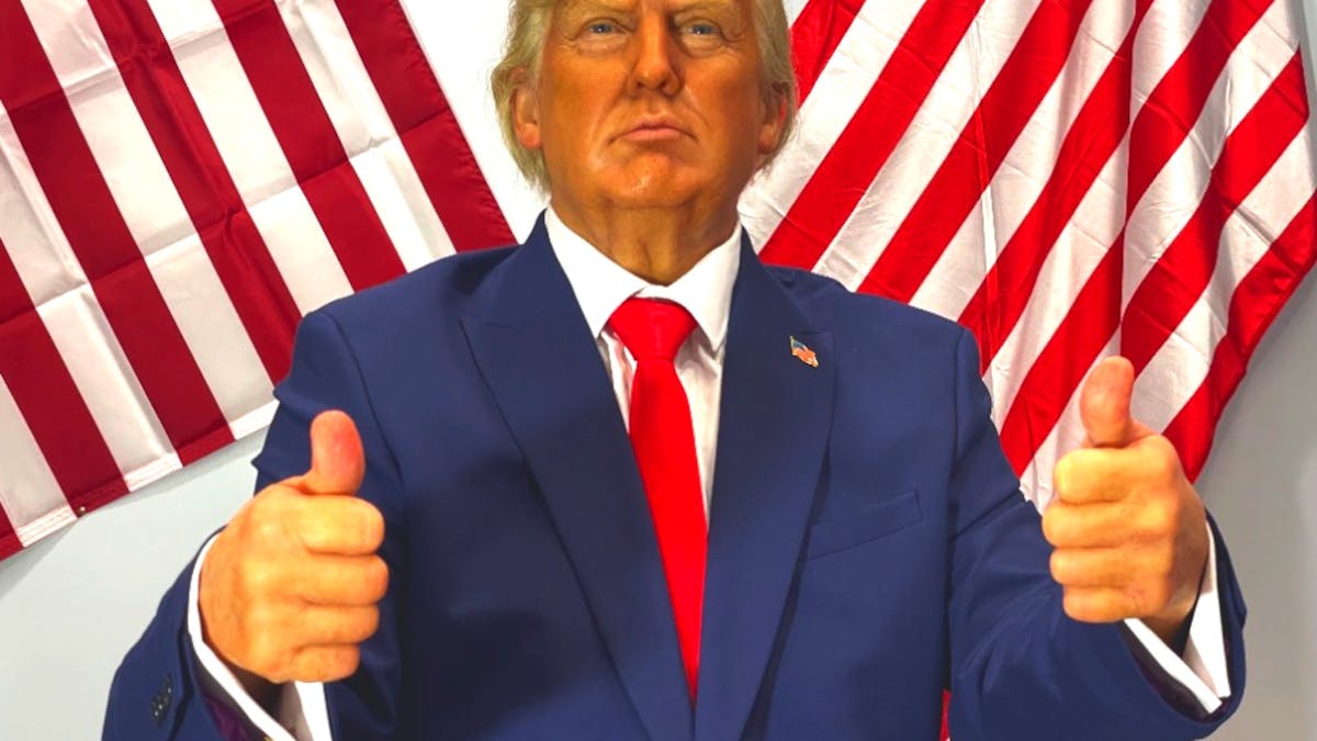 Donald Trump standing Infront of American Flags