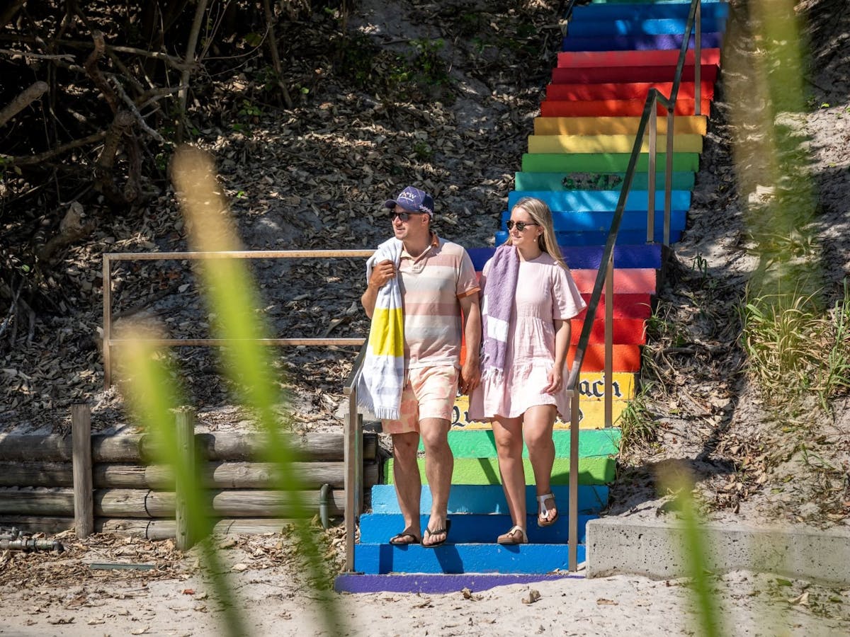 Rainbow coloured stairs leading down to the beach Rainbow coloured stairs leading down to the beach