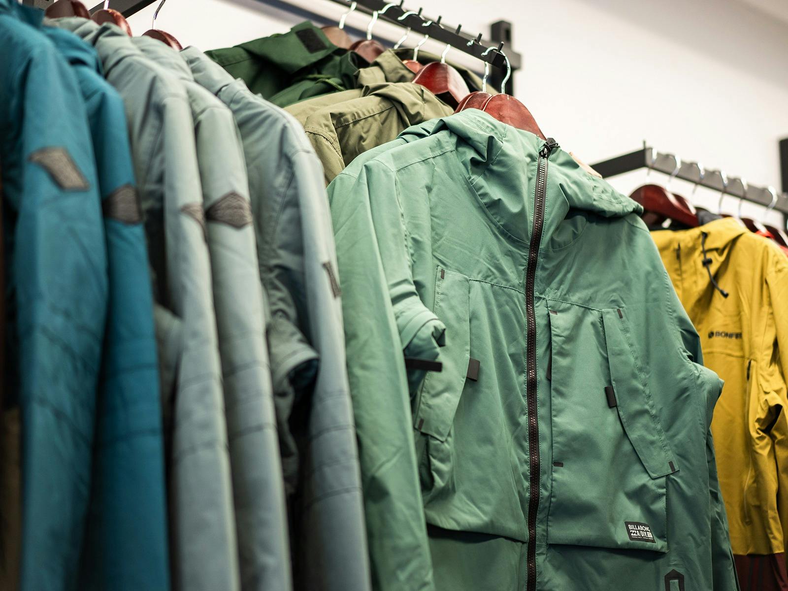 snow jackets hanging on a rack