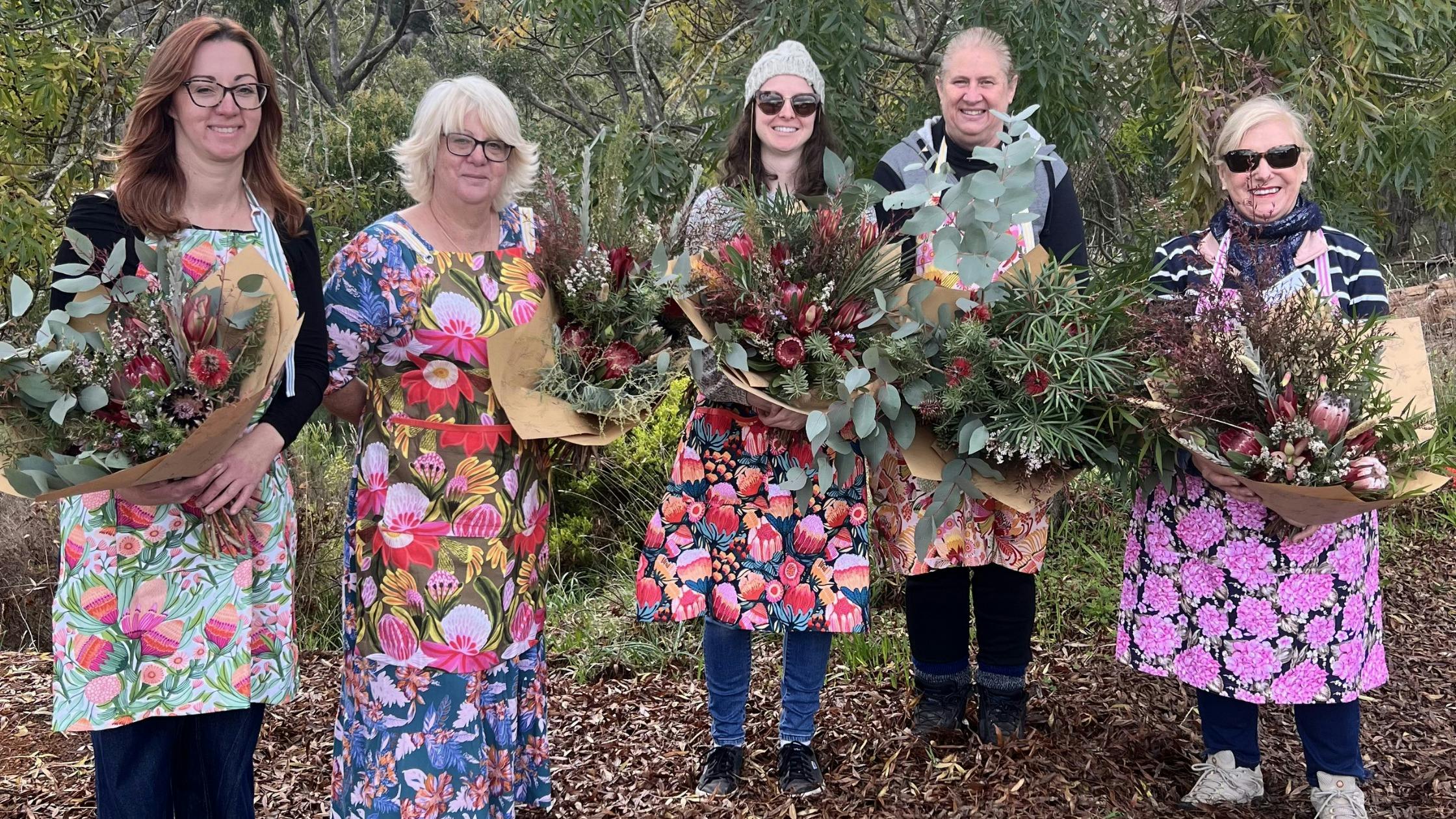 Workshop participants showcasing their unique bouquet creations