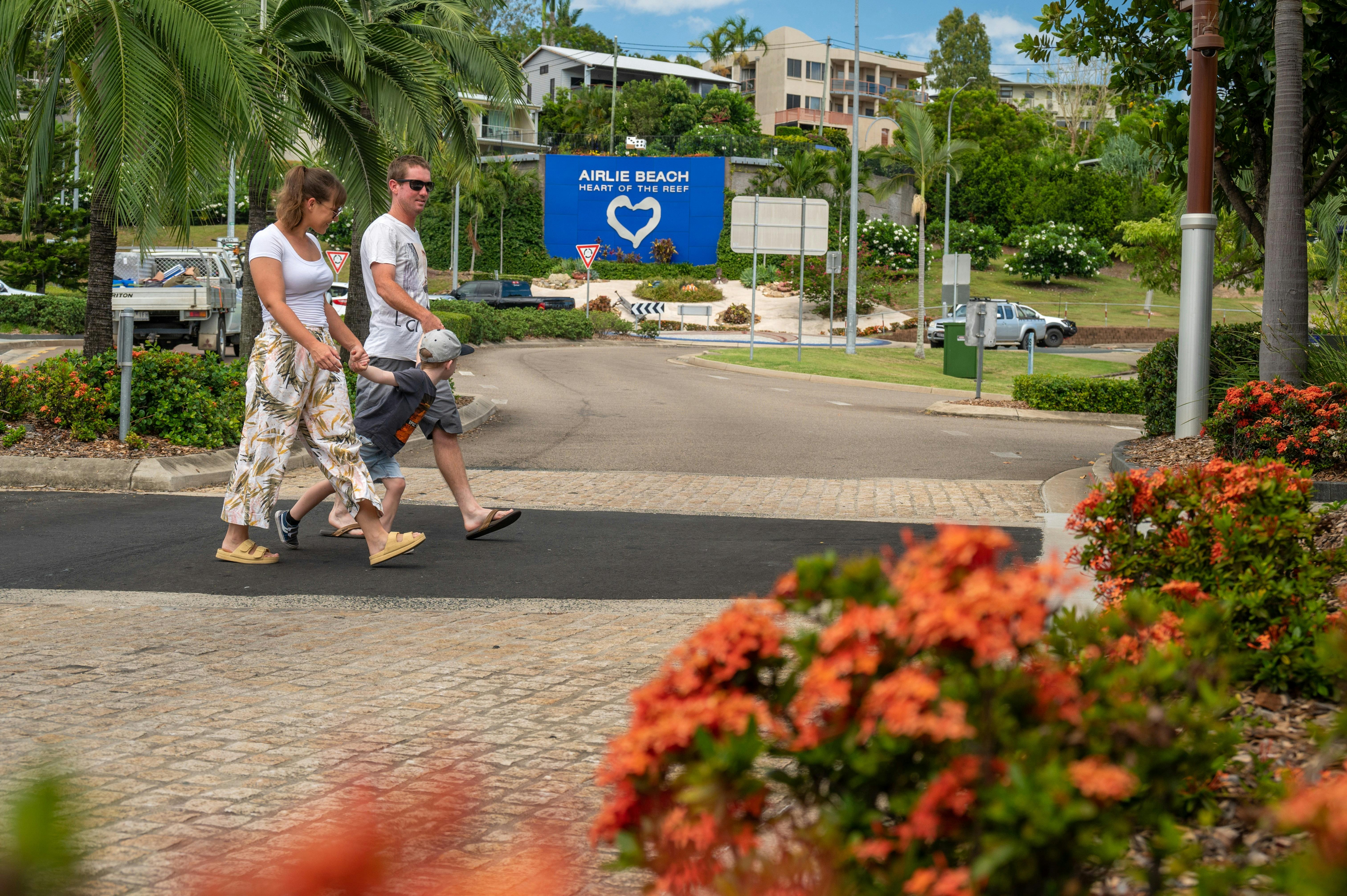 Family crossing the Airlie Beach main street