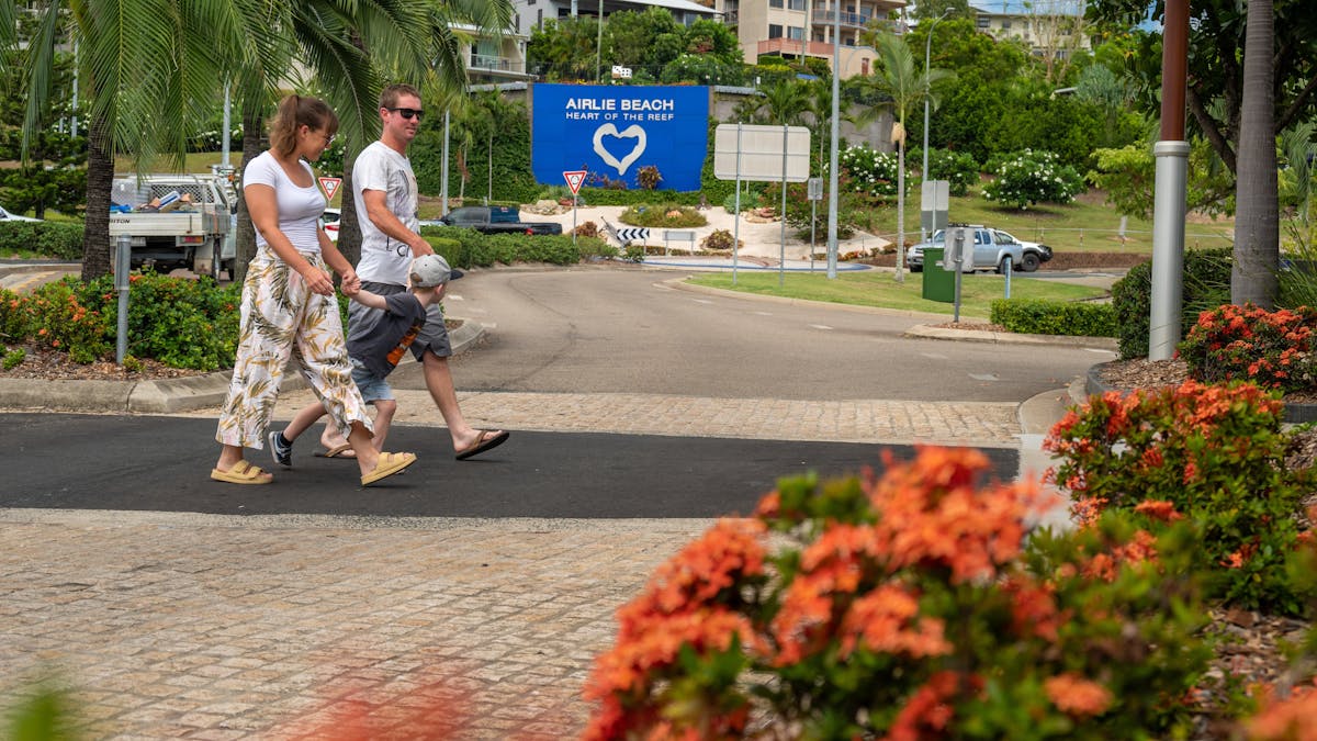 Family crossing the Airlie Beach main street