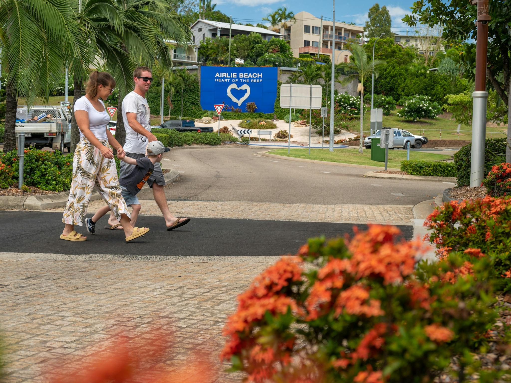 Family crossing the Airlie Beach main street