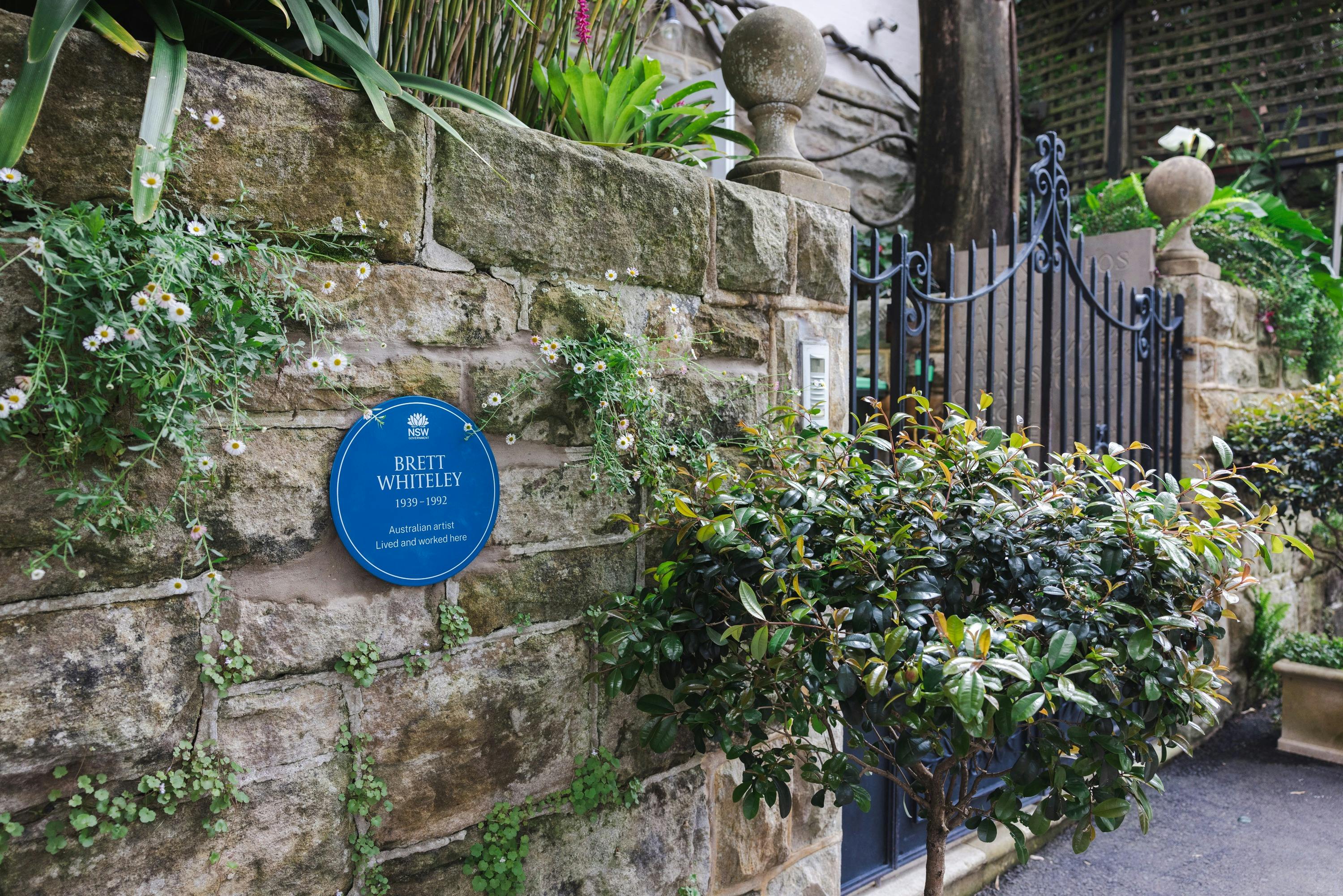 Blue plaque on stone wall next to front gate of Brett Whiteley House