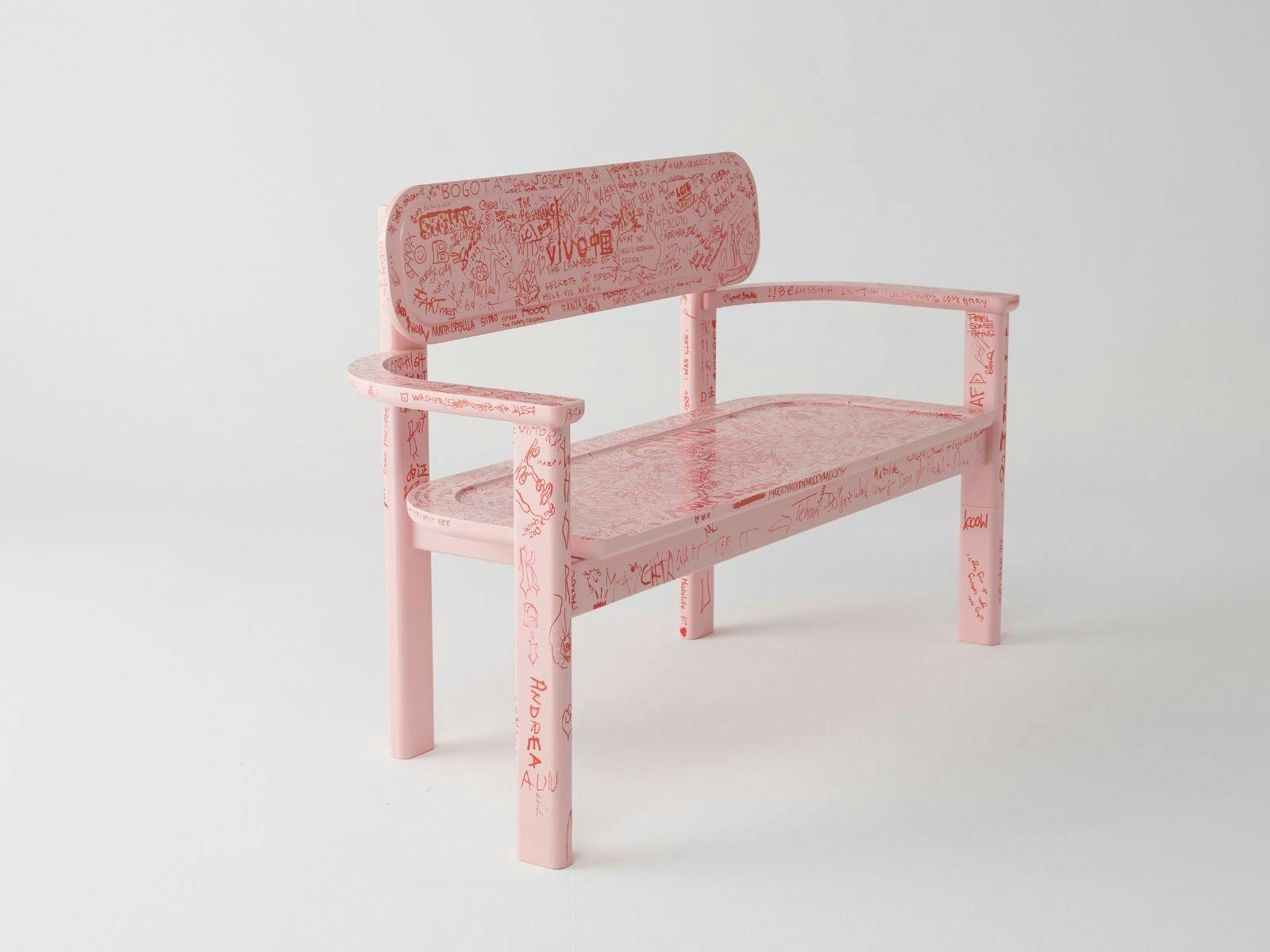 Pink bench seat with images drawn in red ink