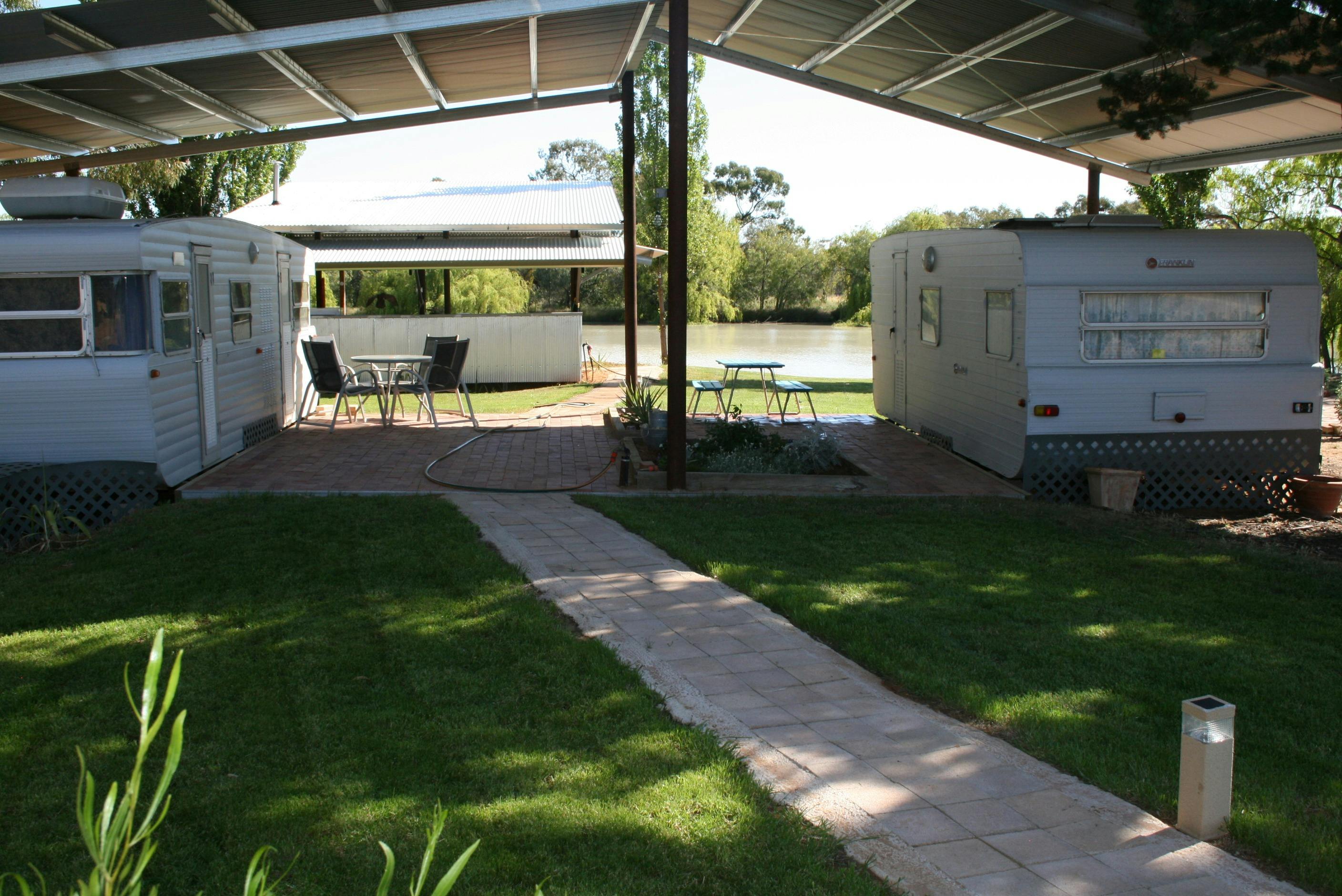 Refurbished vans, each featuring a comfortable queen bed.
