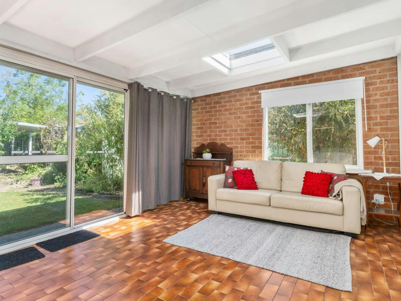 Sunroom with couch and sliding doors to outside