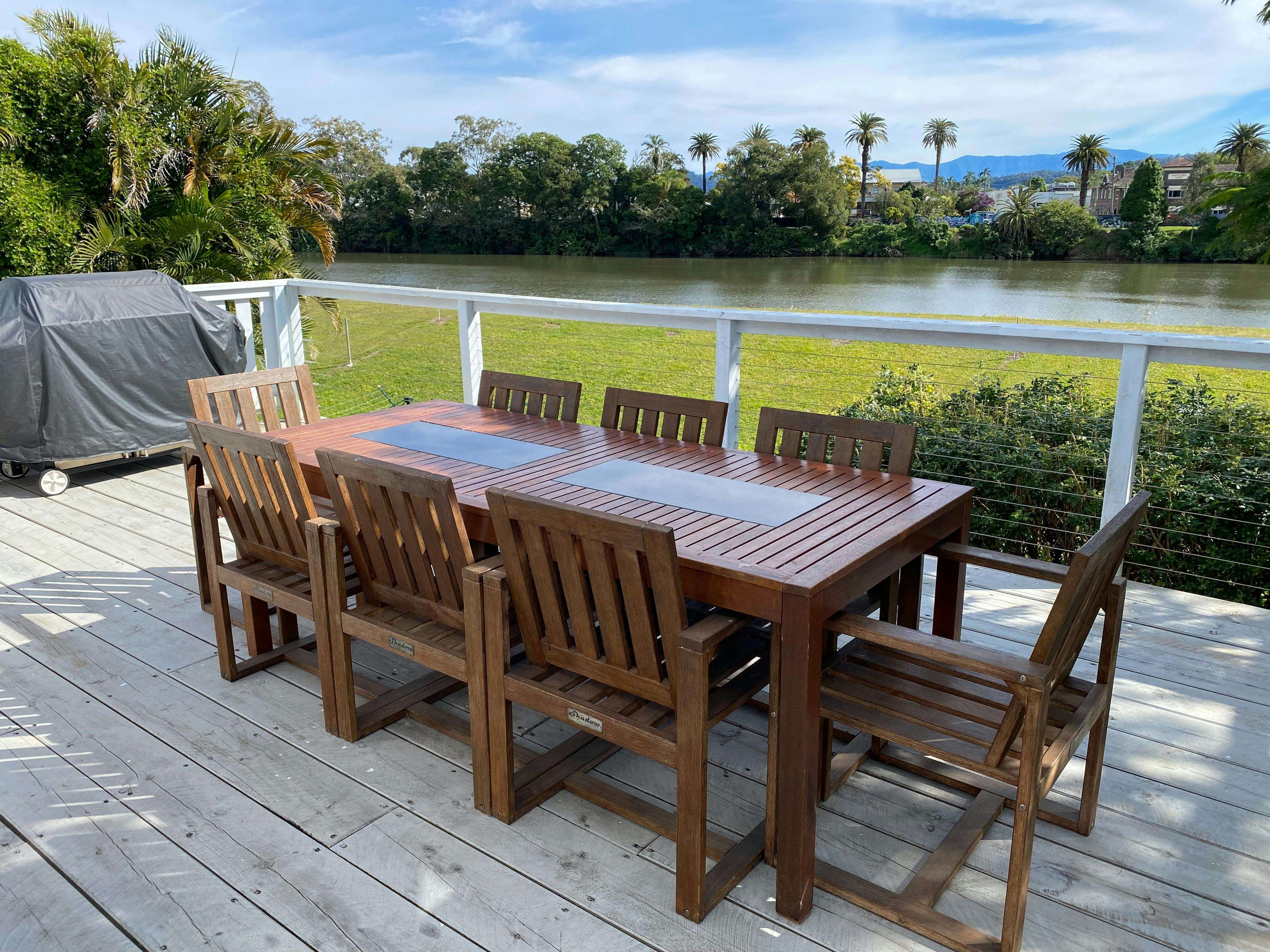 Outdoor patio with 8 seater table and BBQ overlooking the Tweed River