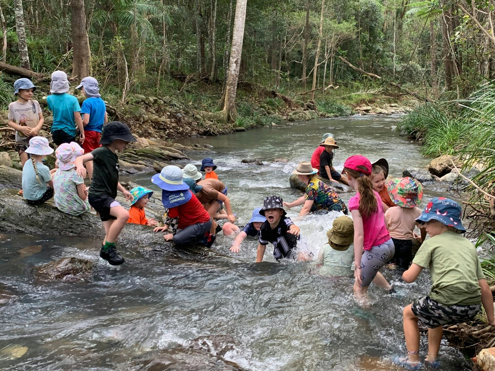 Children playing in creek at Birdwings Forest School Kids Holiday Nature Adventures Gold Coast Hinte Children playing in creek at Birdwings Forest School Kids Holiday Nature Adventures Gold Coast Hinte