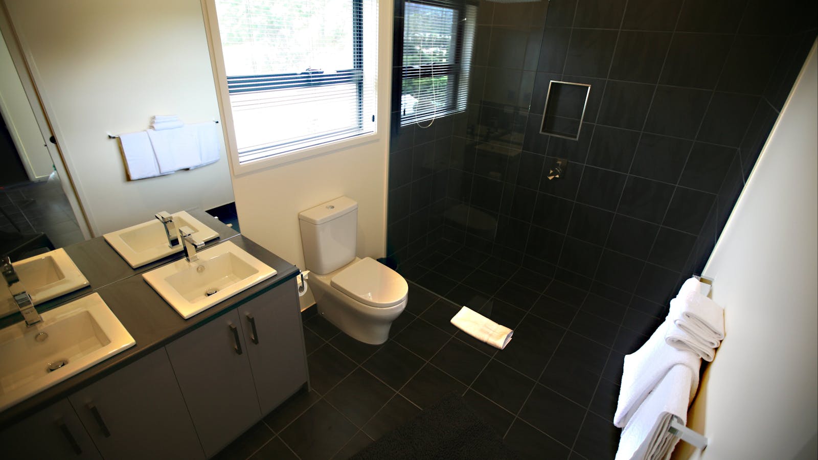 Fresh modern bathroom with walk in rain shower