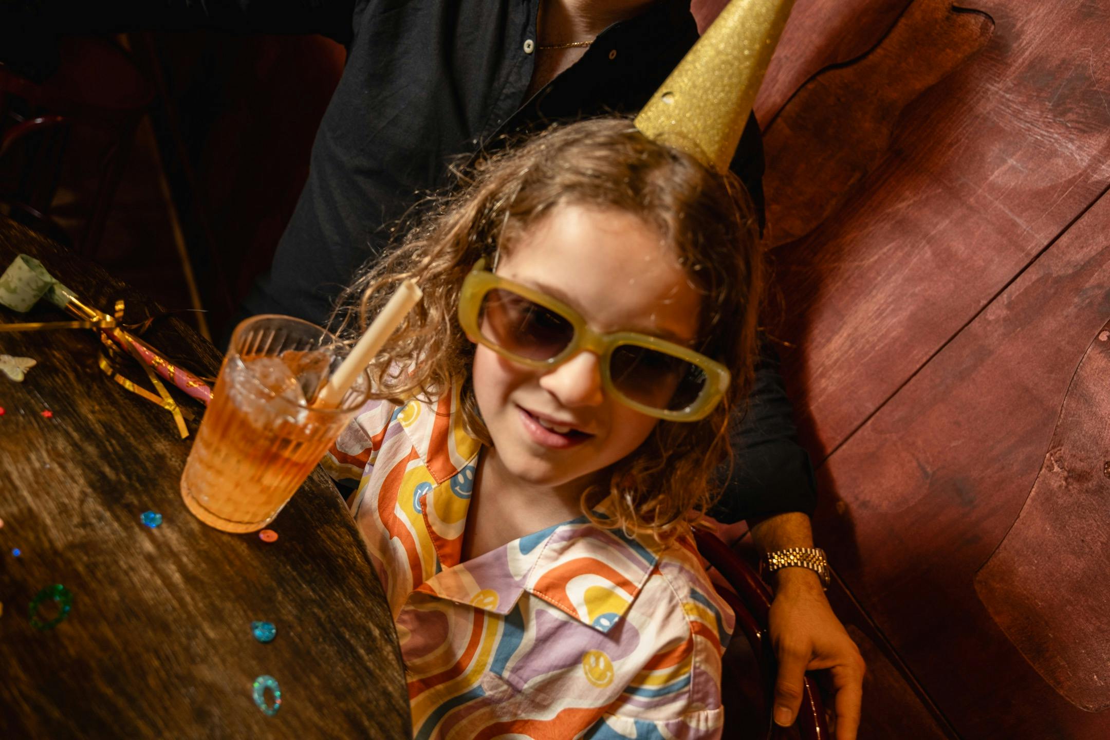 A young boy wearing a party hat at Bar Beirut
