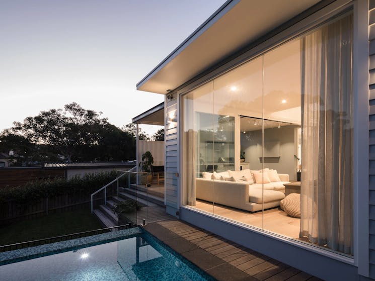 The large living room with pool views