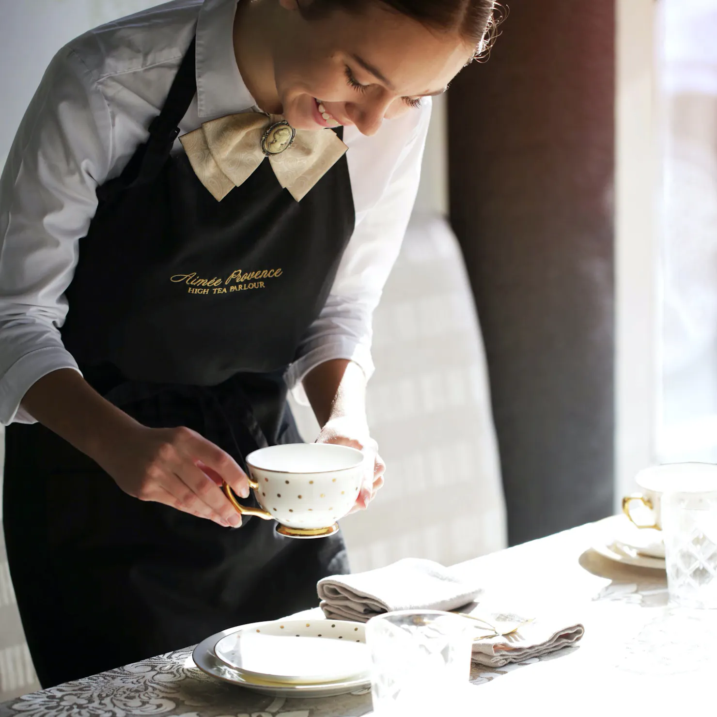 placing a tea cup on the table at aimee provence