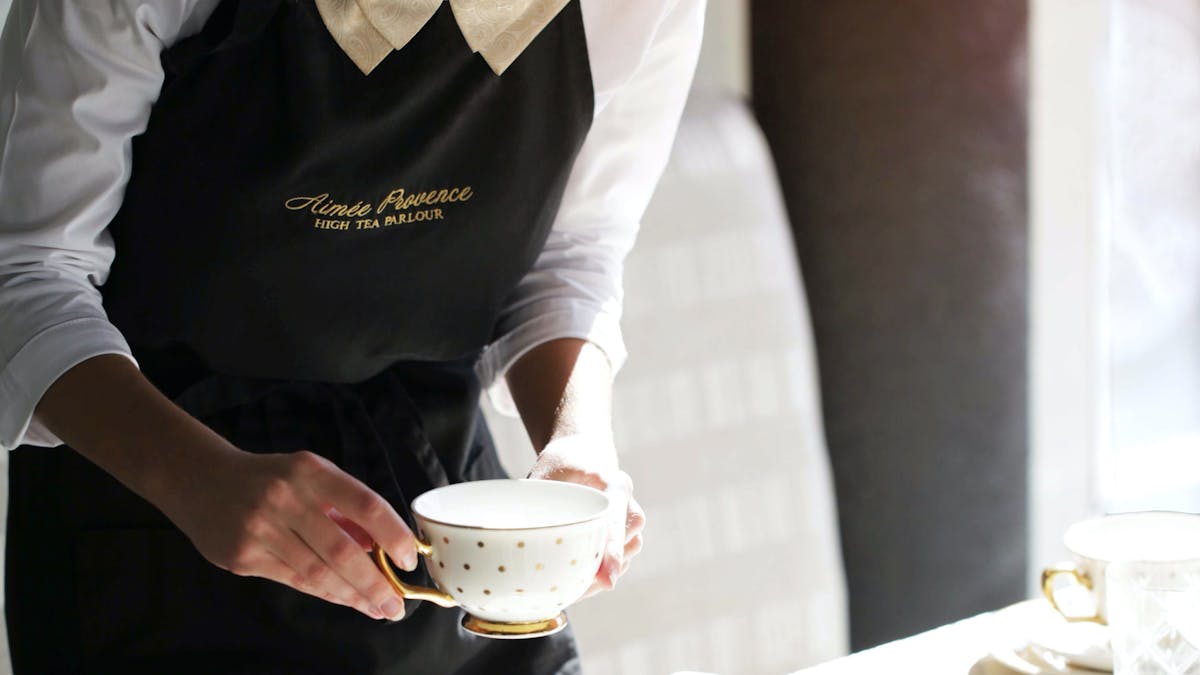 placing a tea cup on the table at aimee provence