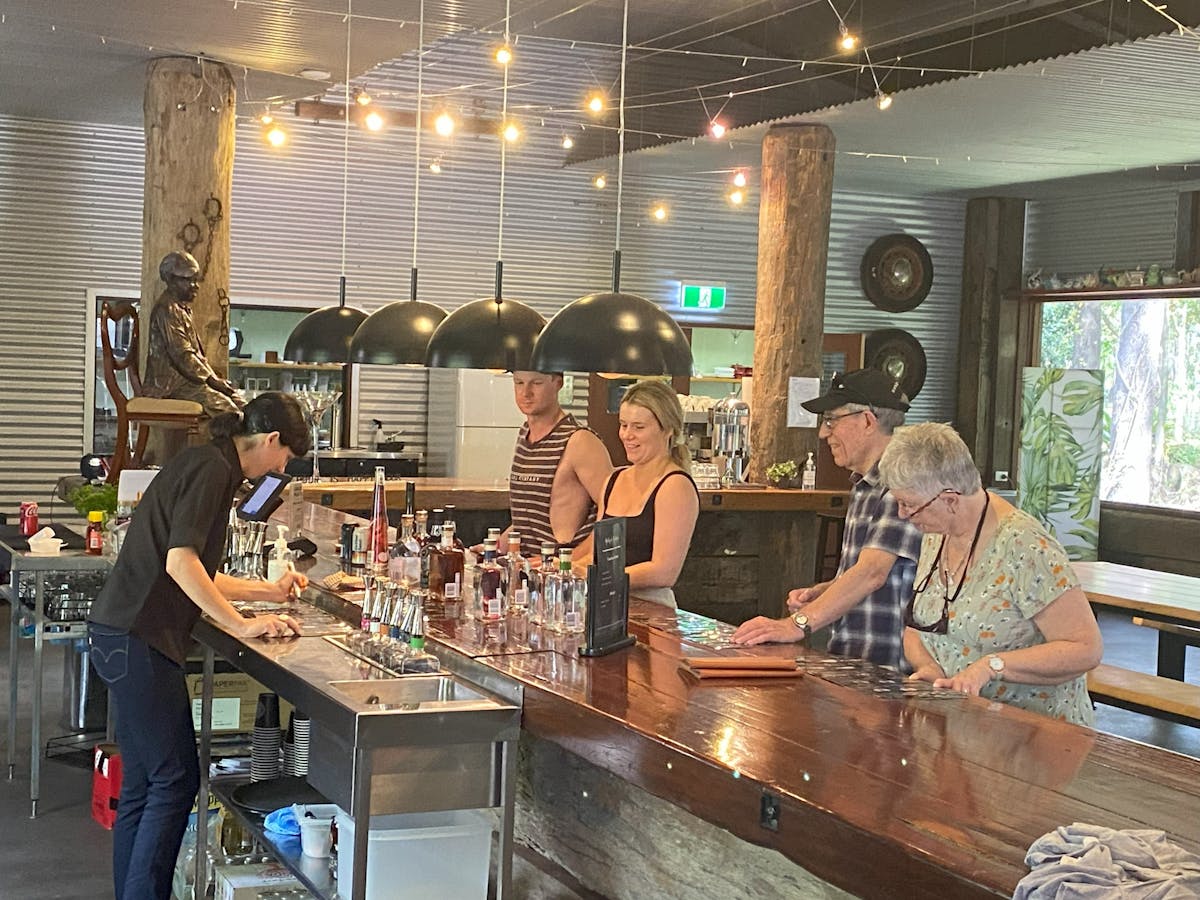 Four travellers on Taste of Tablelands tour enjoying tastings of 4 selections of liquors and spirits