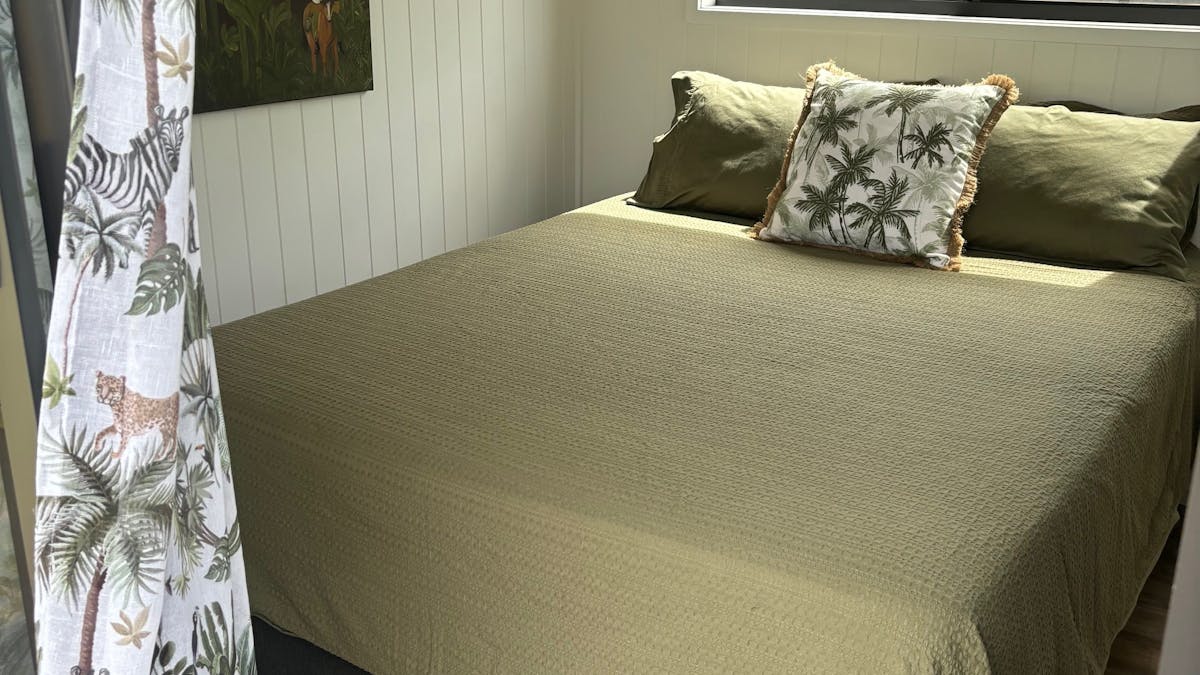 Queen bed offering privacy and comfort in the Tiny Homes at High Valley Dawn Permaculture Farm