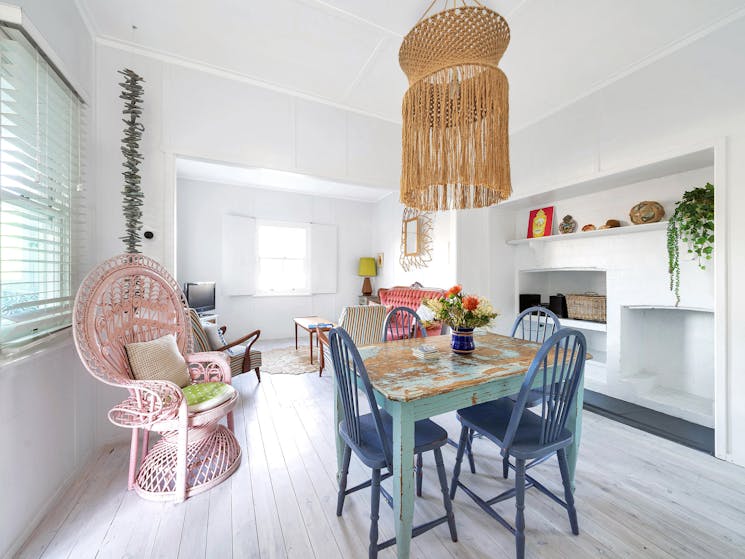 Dining and living rooms, with pink Peacock Chair