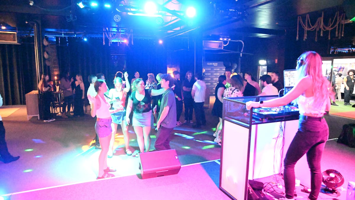 Bright lights shine on a full dancefloor on Club Noir's Night Club Night