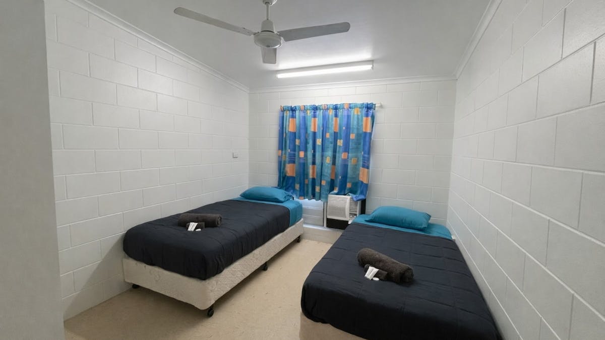 Twin single room Includes 2 single beds with linen provided, air conditioning, and  shared bathrooms