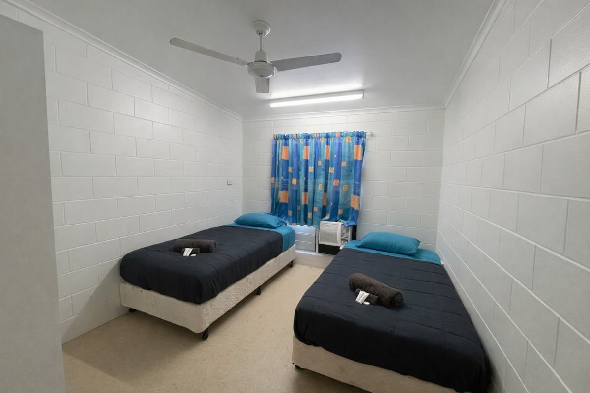 Twin single room Includes 2 single beds with linen provided, air conditioning, and shared bathrooms