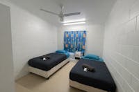Twin single room Includes 2 single beds with linen provided, air conditioning, and shared bathrooms