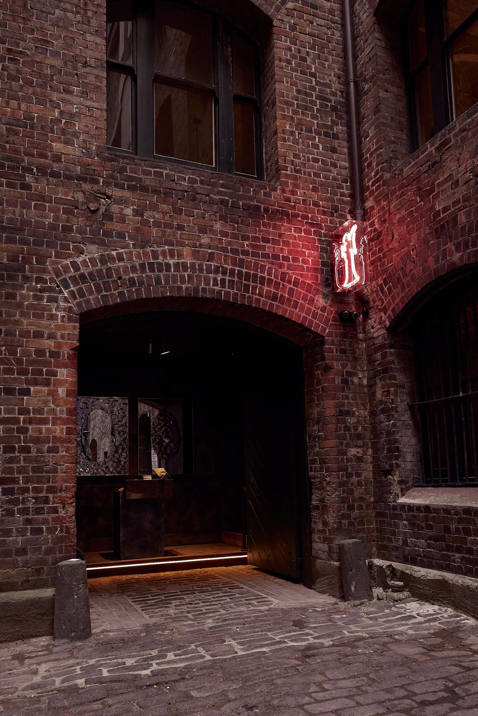 Letra House's exterior, with a the fluorescent angel icon above the entrance.