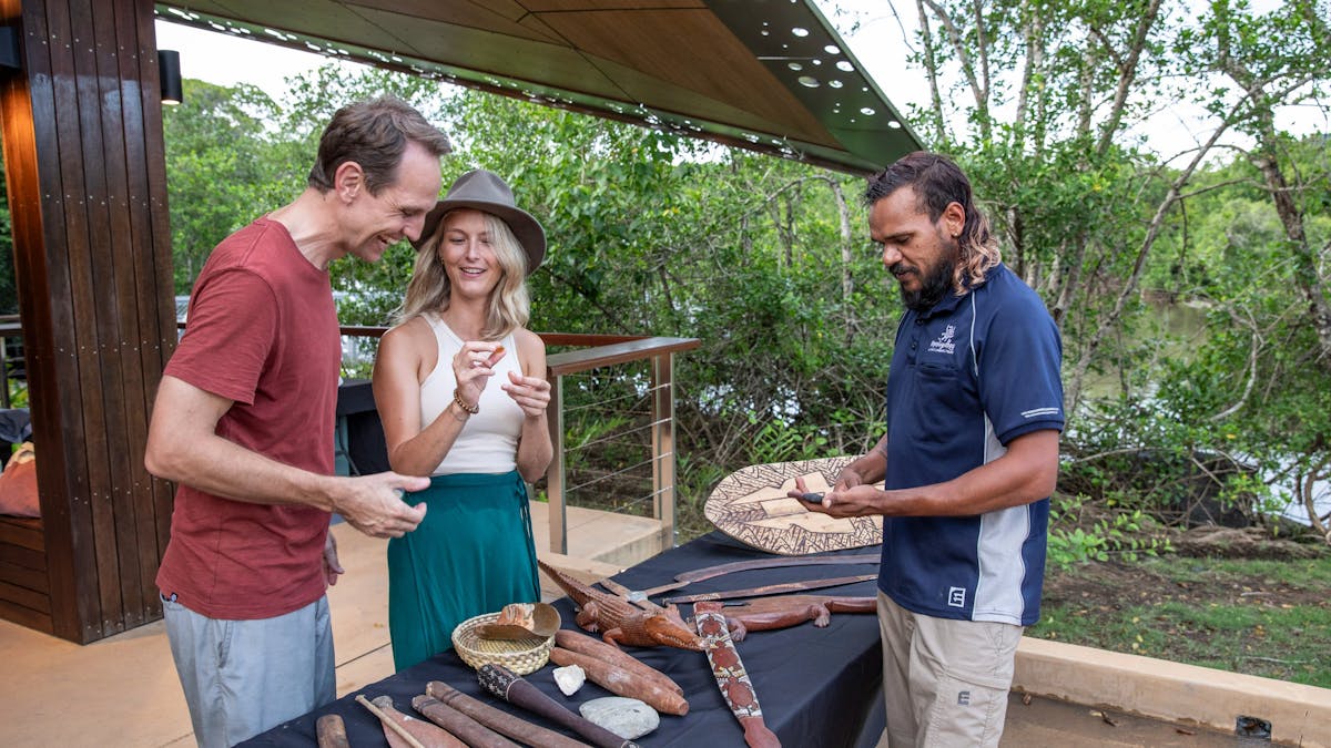 Mandingalbay guide with guests presenting traditional implements and weapons