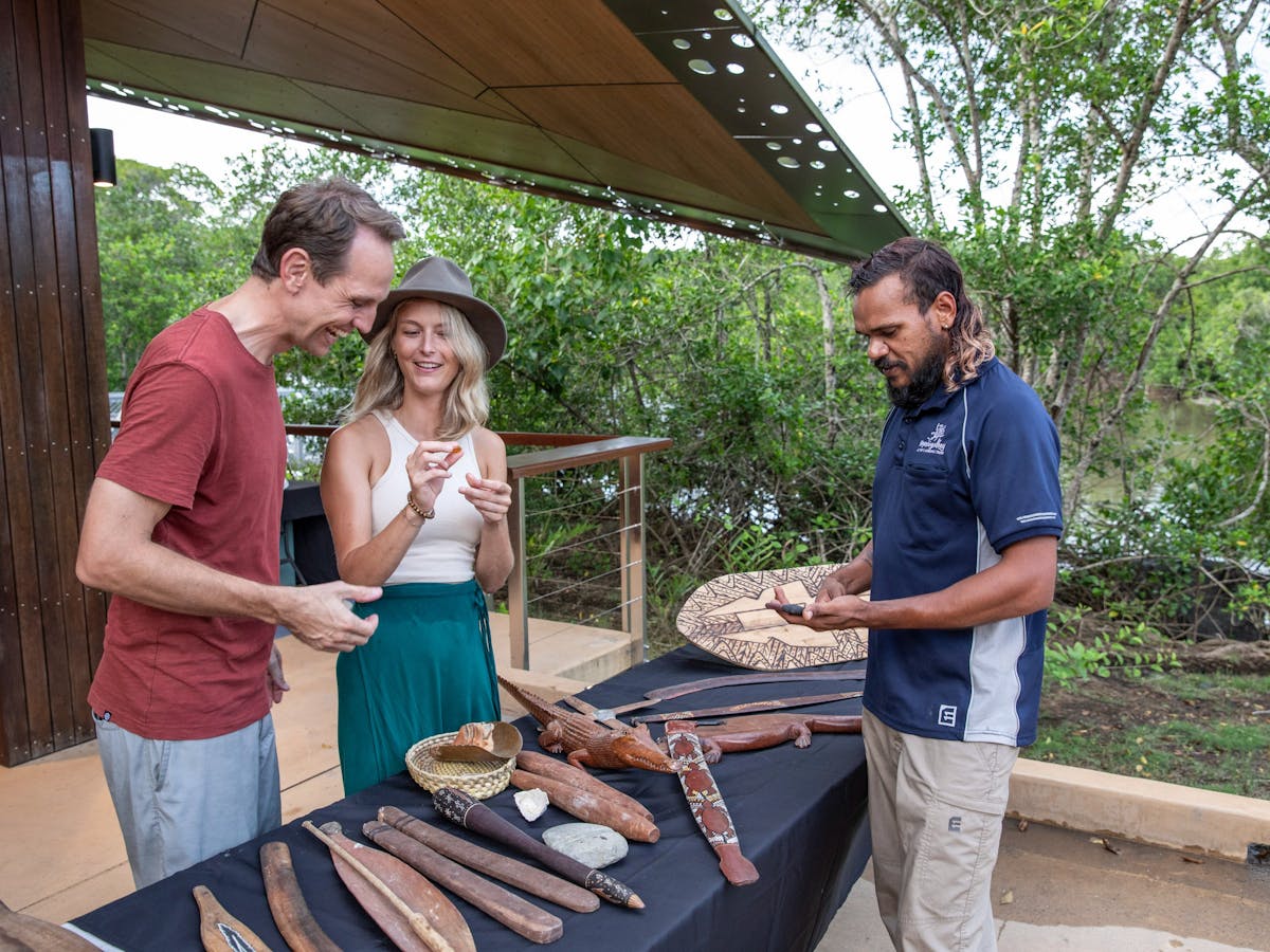 Mandingalbay guide with guests presenting traditional implements and weapons