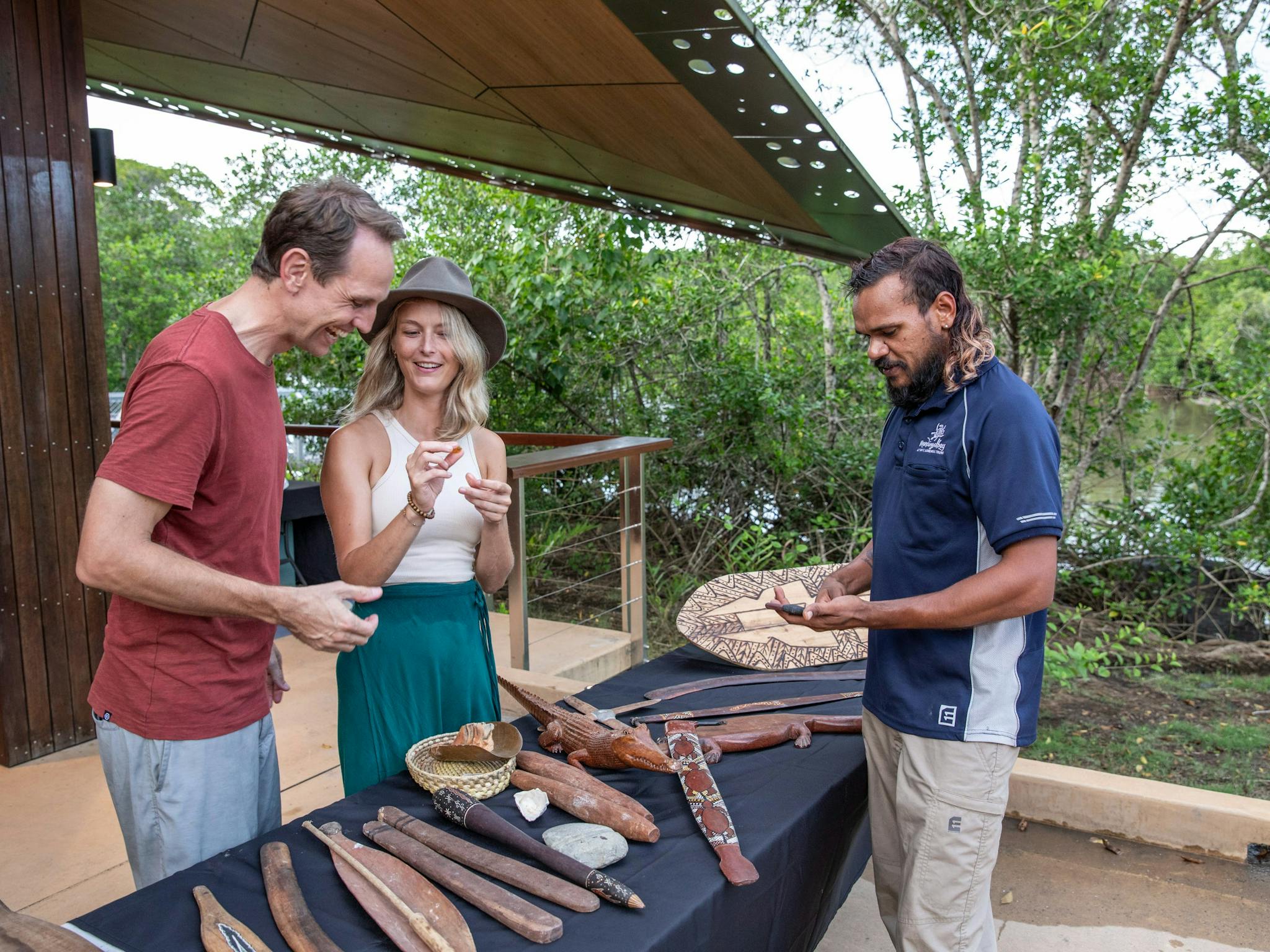 Mandingalbay guide with guests presenting traditional implements and weapons Mandingalbay guide with guests presenting traditional implements and weapons