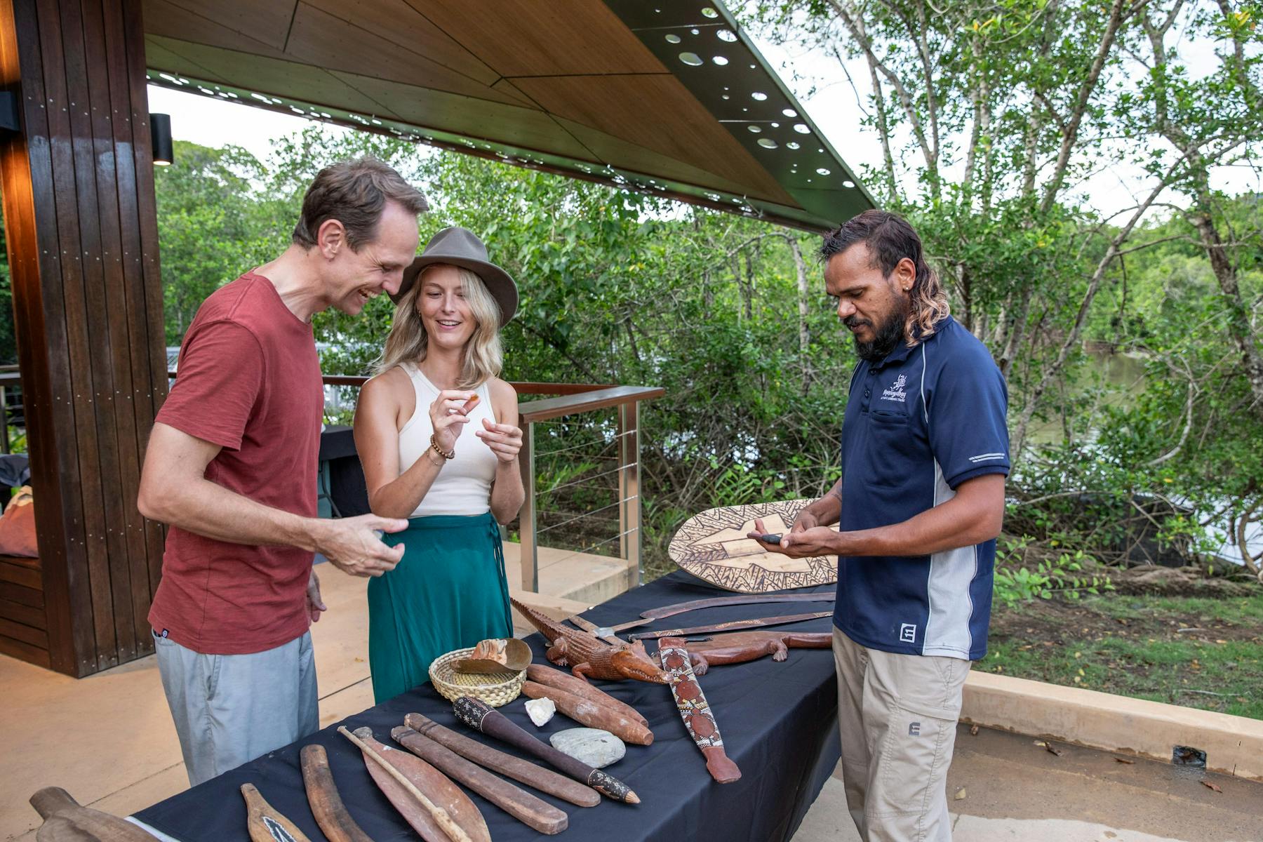Mandingalbay guide with guests presenting traditional implements and weapons