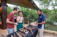 Mandingalbay guide with guests presenting traditional implements and weapons