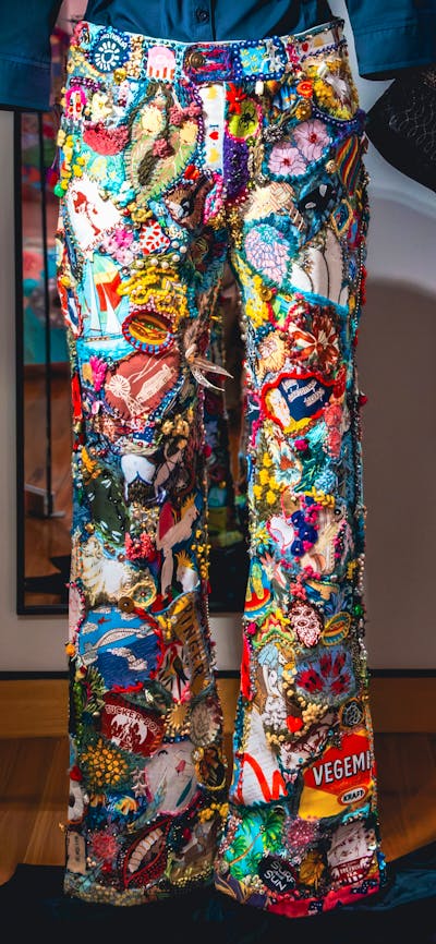 Anyone Seen Those Old Jeans by Wendy Saclier. Detailed shot of jeans, embroidered with bright motifs