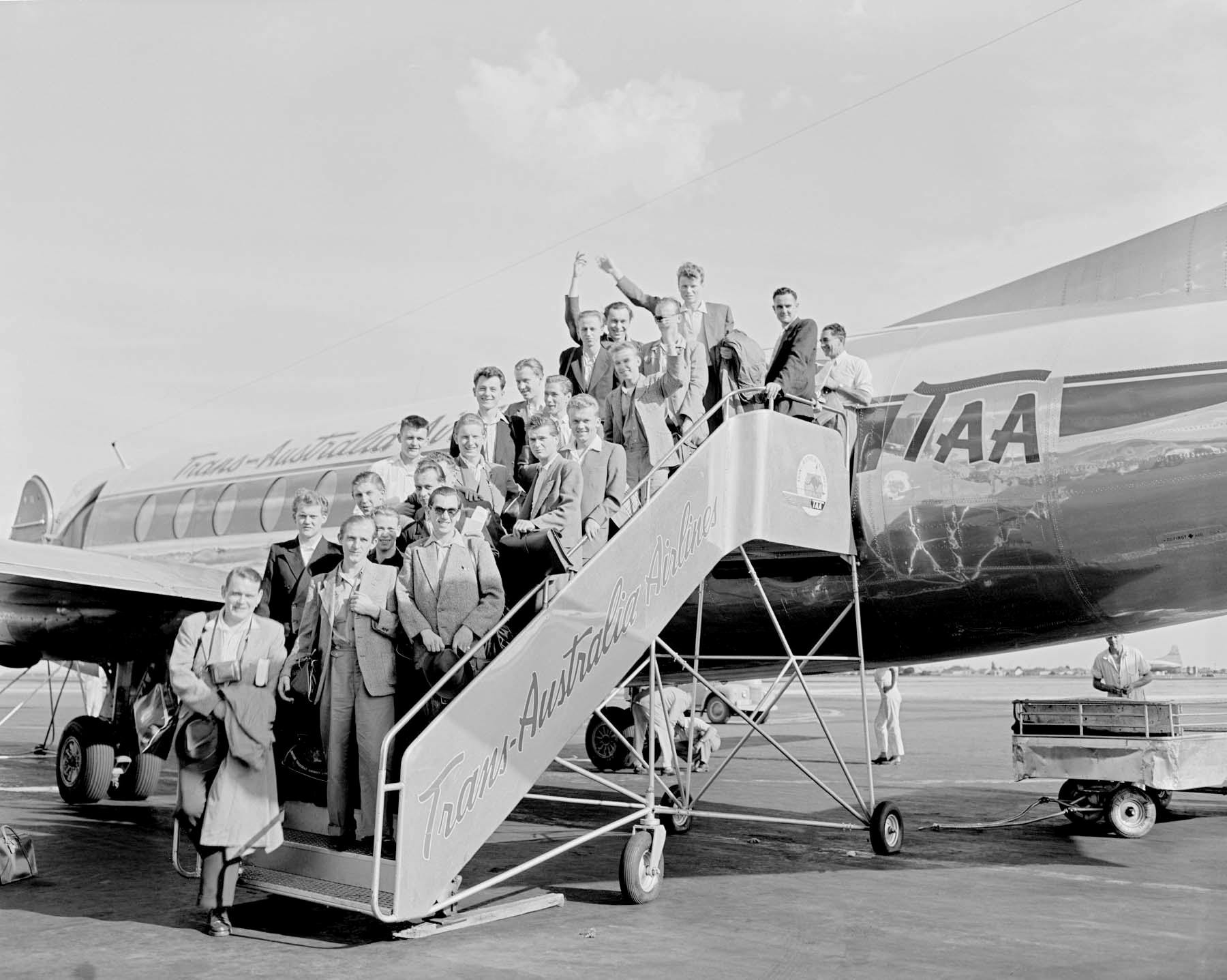Black and white archival photo of a German family boarding a plane