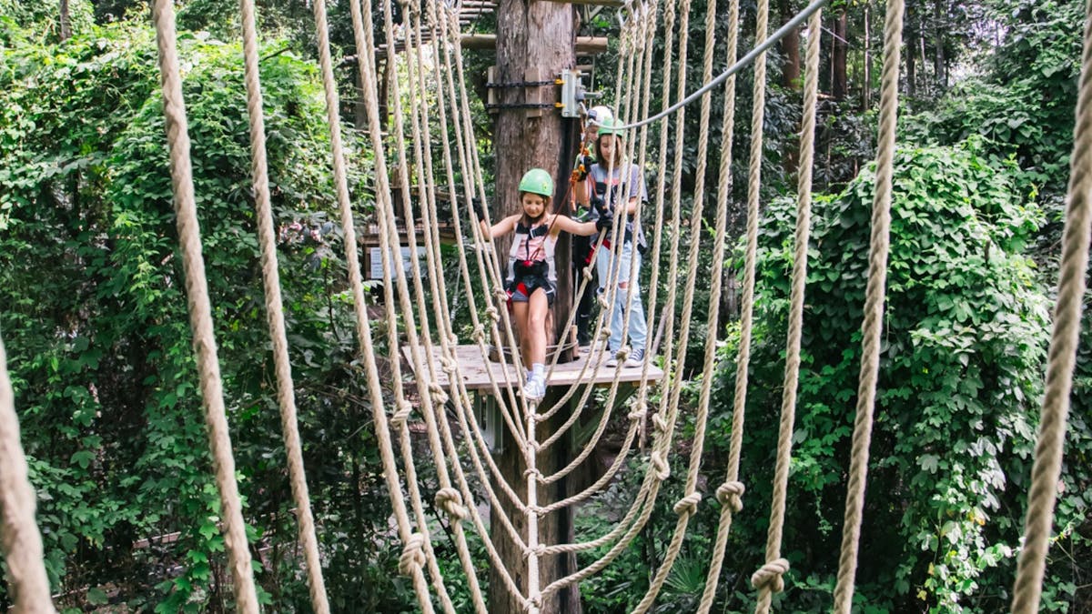 Young girl starting a Rope tightrope bridge