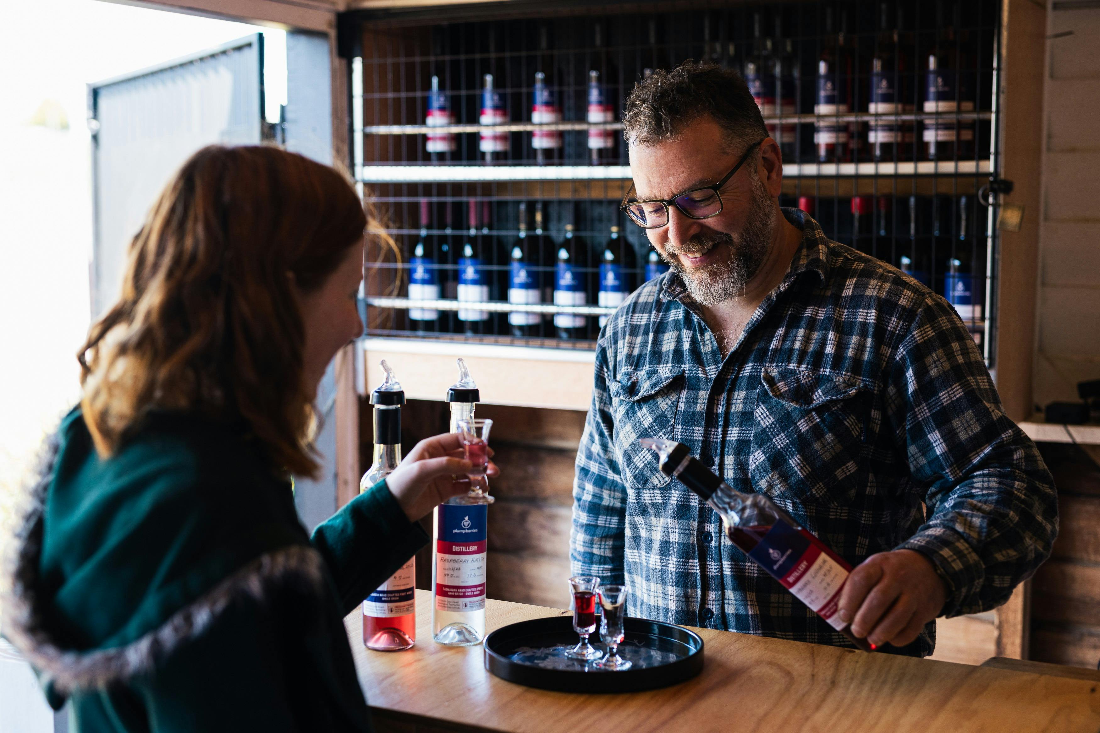 Man serving women raspberry liqueur