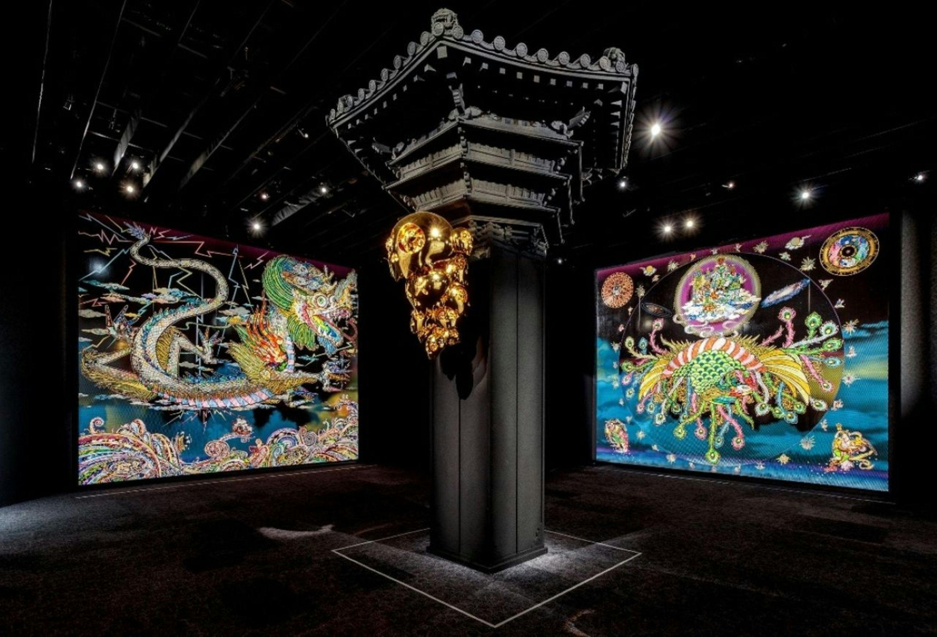 A photo of a black room decorated with gold and vibrant paintings by Takashi Murakami