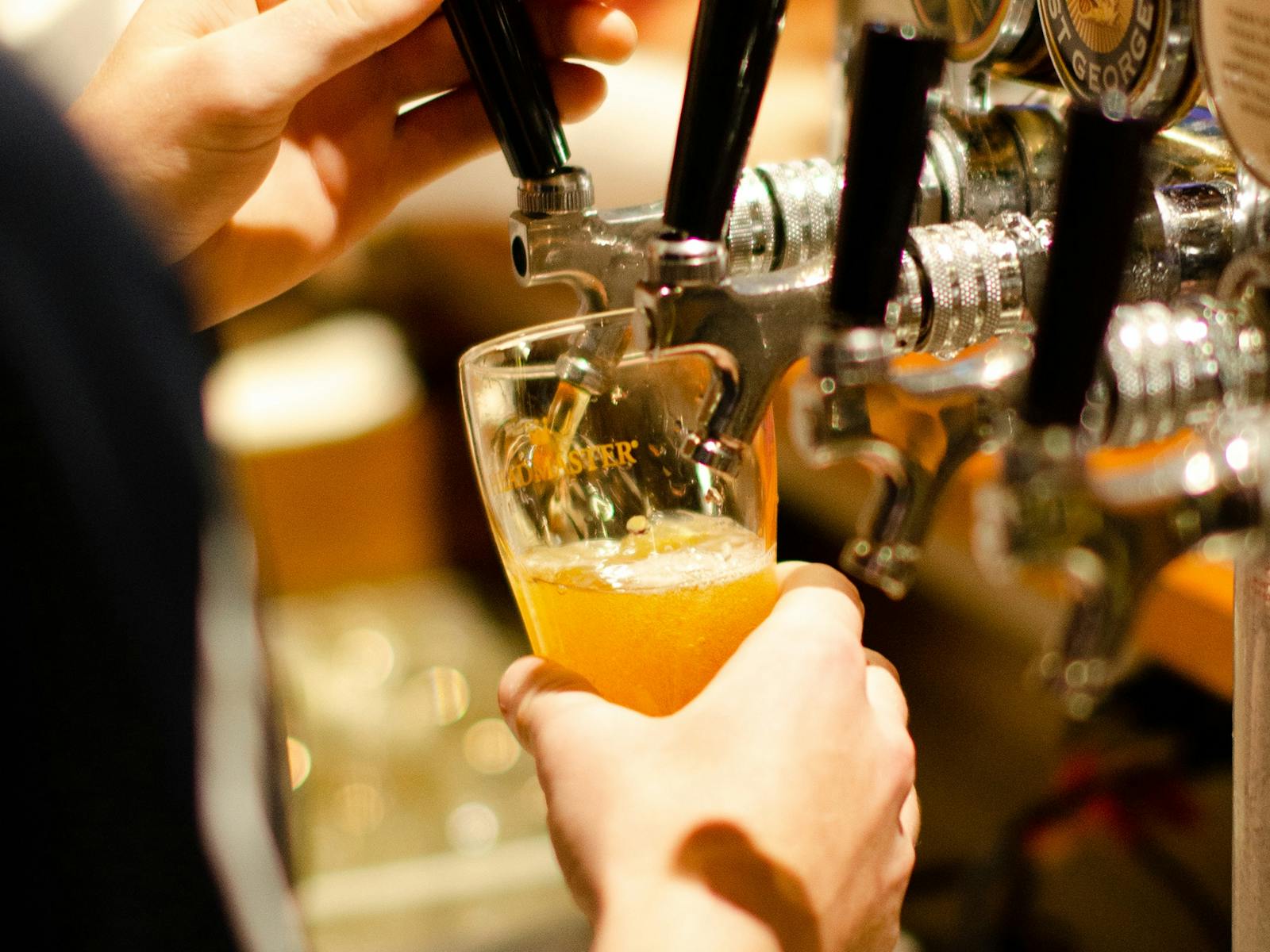 Close up of beer being poured from the tap into a glass