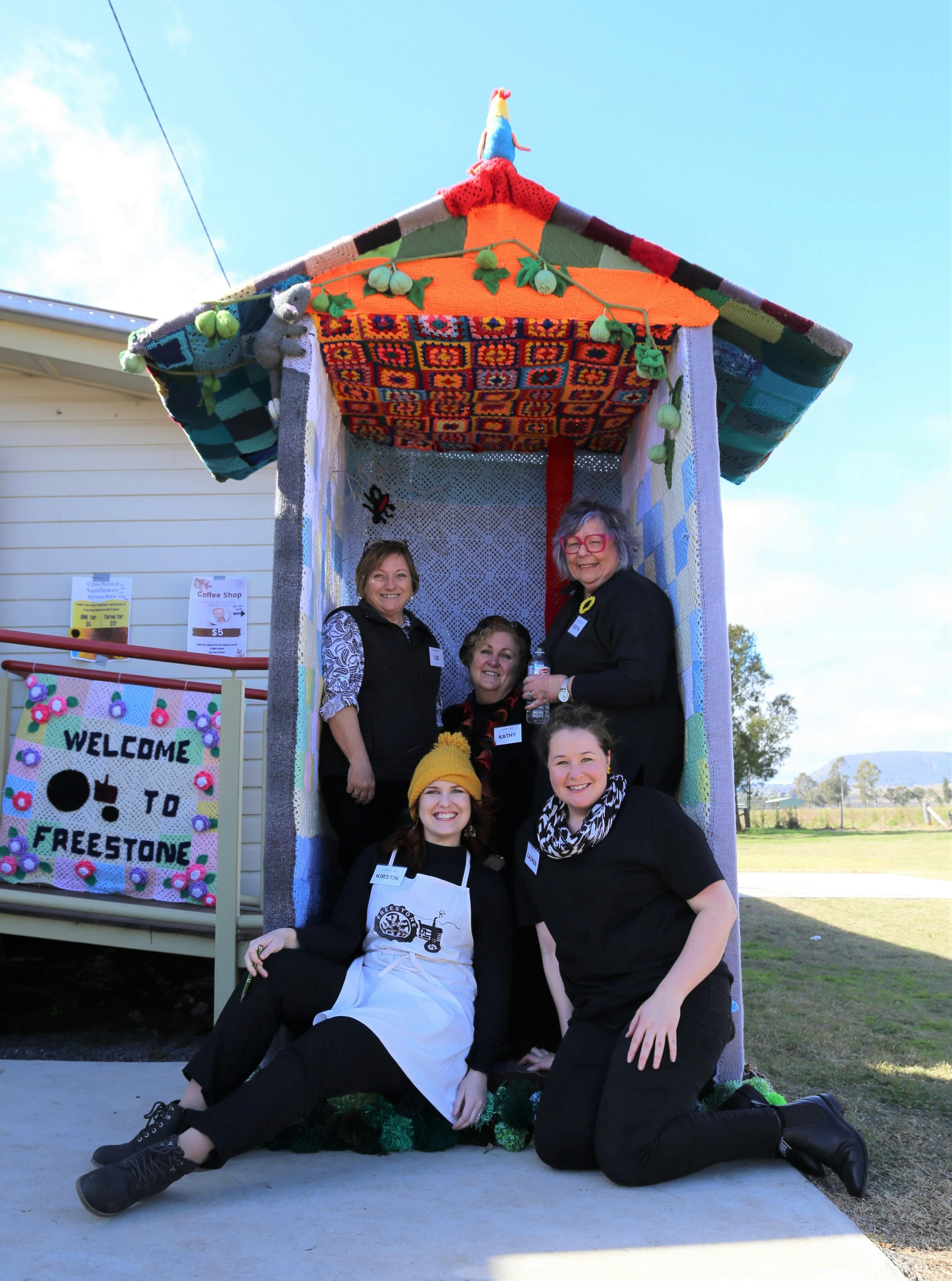 Freestone Hall  volunteer sitting a yarnbombed toilet
