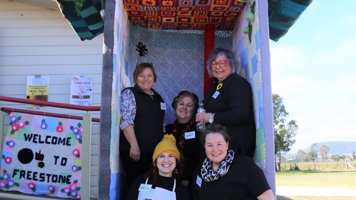 Freestone Hall  volunteer sitting a yarnbombed toilet