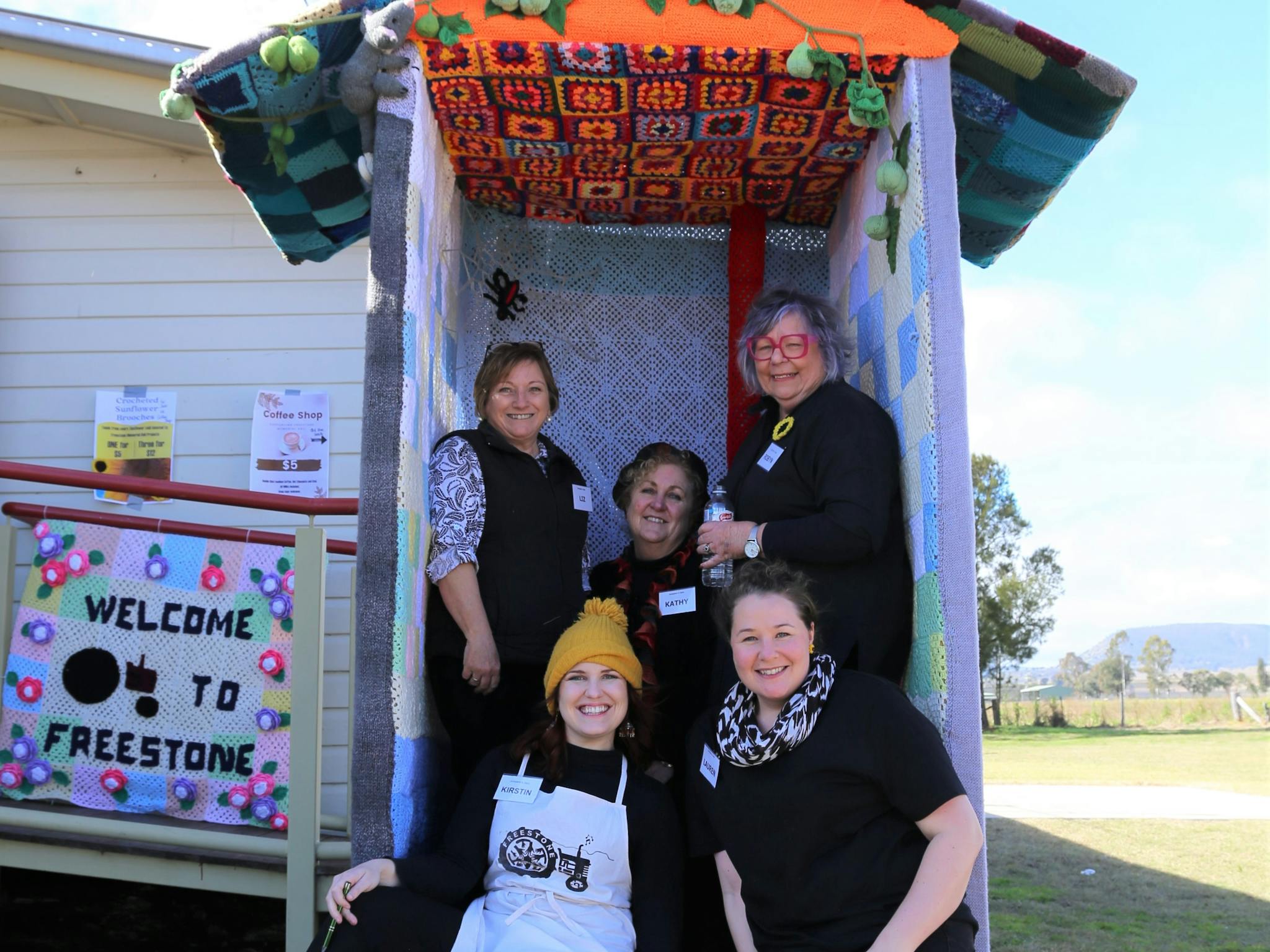 Freestone Hall  volunteer sitting a yarnbombed toilet