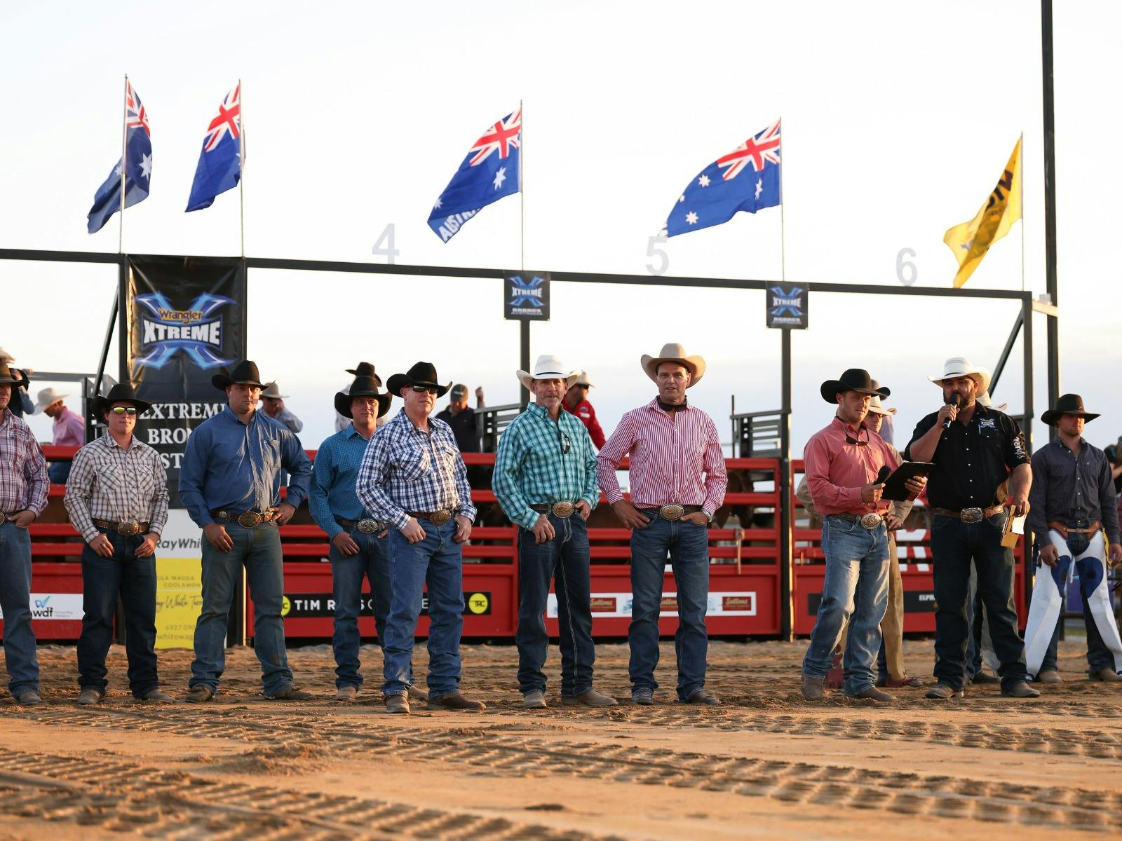 A line up of cowboys facing the crowd