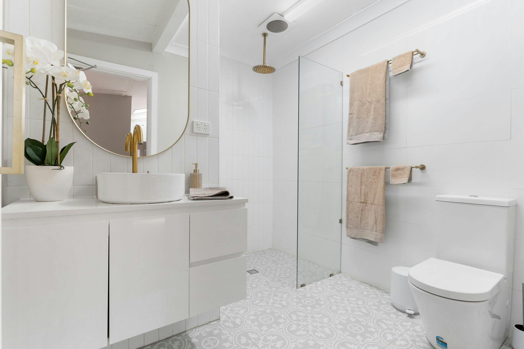 Shower, toilet and vanity in modern bathroom