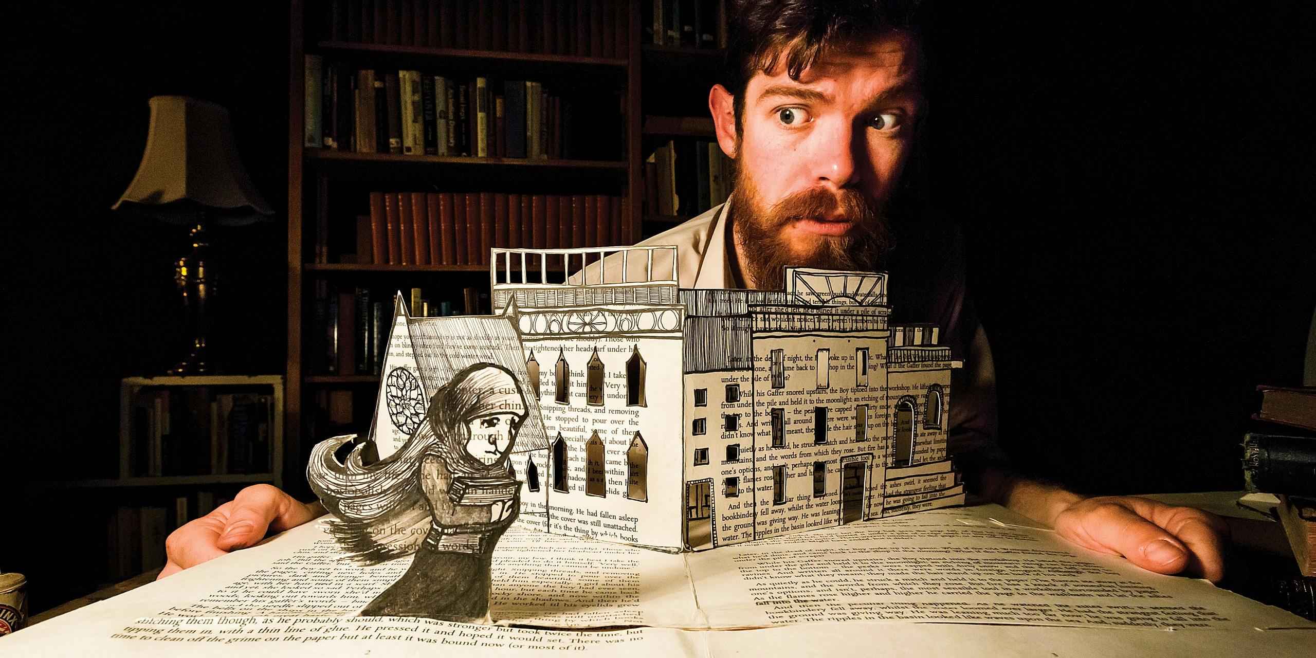 a 3D book and a man behind