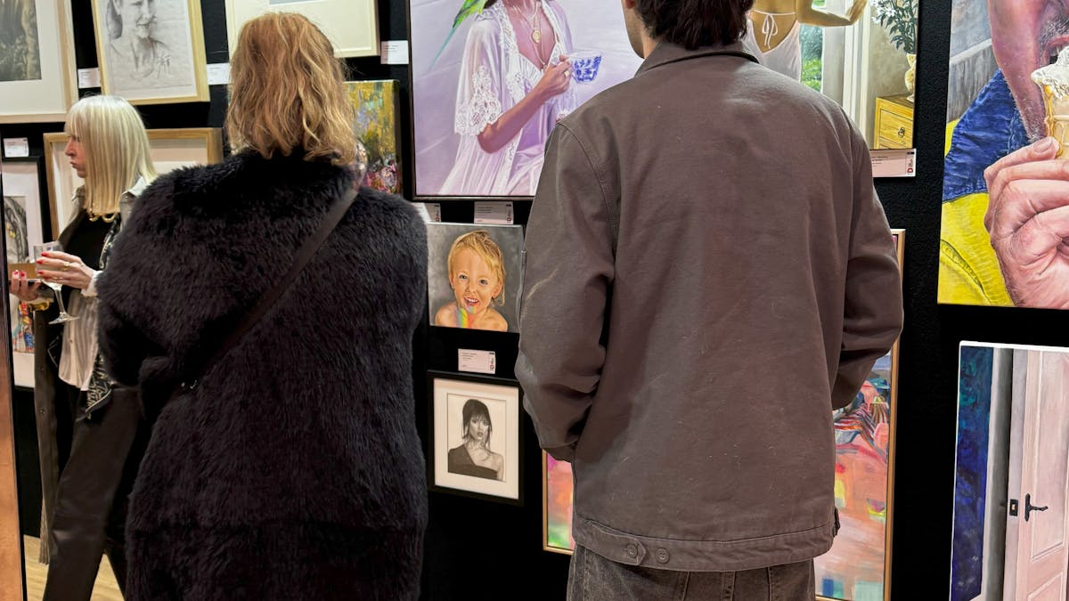 Visitors look at portrait section of Doyles
