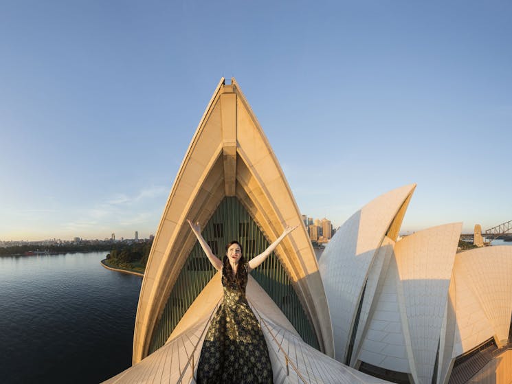 An opera singer sings on top of the sails of the Sydney Opera House